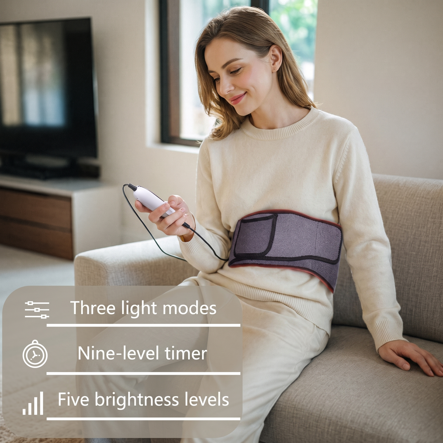 Woman relaxing on a sofa using the LUNA far-infrared red-light wrap around her waist — three light modes, nine-level timer, five brightness levels