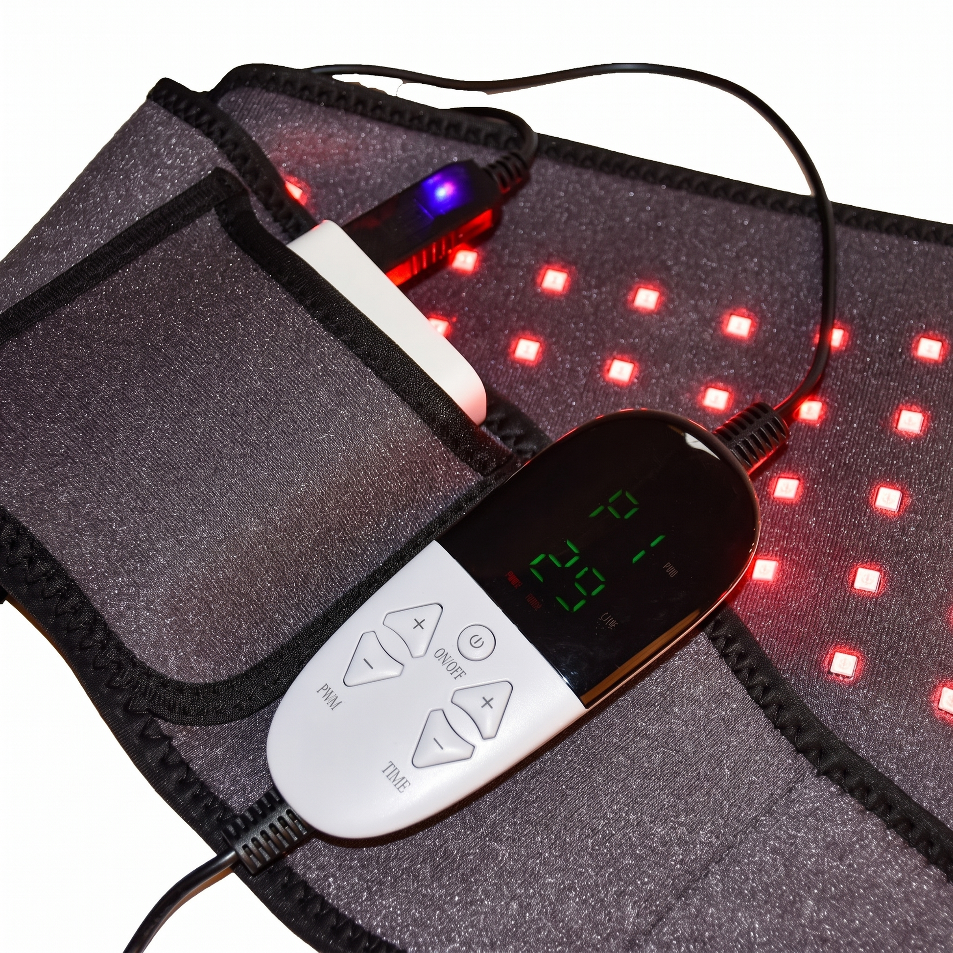 Close-up of the LUNA wrap with red-light therapy LEDs glowing and the USB controller's lit digital display